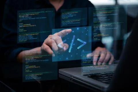 Programmer or developer working on laptop, with virtual screens displaying .. Photos