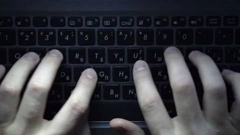 Programmer or Hacker quickly types on the keyboard cracking an Access Code Stock Footage 122773026