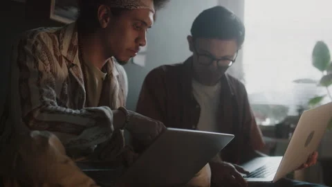 Programmer Pointing at Laptop Screen while Explaining Code to His Friend Video stock 290869973