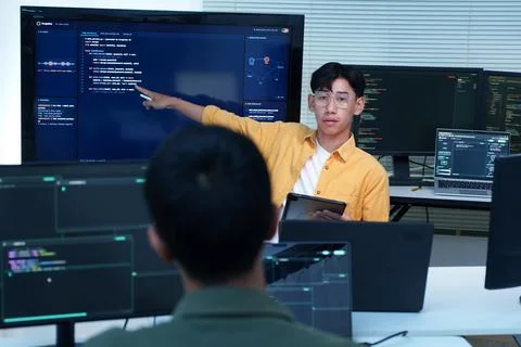 Programmer Presenting Artificial Intelligence Code to Colleague Fotos Stock