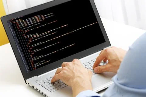 Programmer profession - man writing programming code on laptop computer 스톡 사진