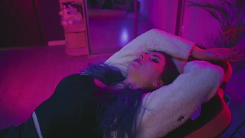 Programmer Reclines in Neon Studio for Nap Break Stock Footage 307459461