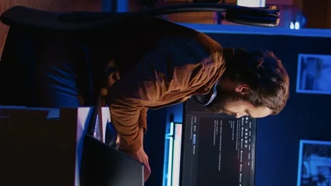 Programmer removing headphones to better concentrate on difficult IT task Stock Footage 265108958