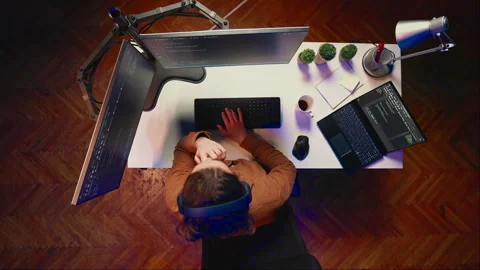 Programmer removing headphones to better concentrate on difficult IT task Stock Footage 265514284