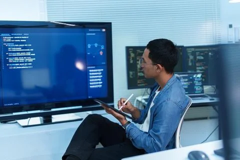 Programmer Reviewing Code and Digital Data Stock Photos