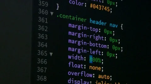 Programmer scrolling up and down for editing page of html css website code ed Stock Footage 79997643