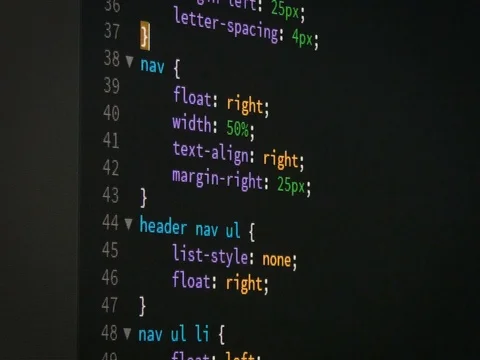 Programmer scrolling up and down page of html css website code editor Stock Footage 79996600