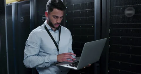 Programmer, server room and laptop for system maintenance, cloud computing or Stock Footage 262223454