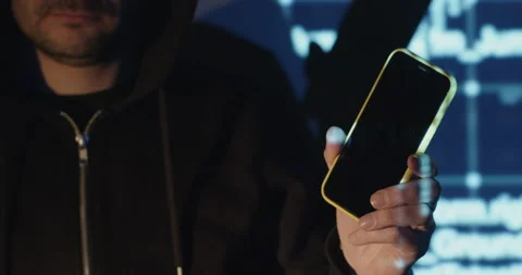 Programmer shows mobile phone against blue digital screen Video stock 190261633