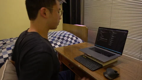 Programmer Sits In Front Of Laptop With Visual Studio Code On Screen. Stock Footage 165196296