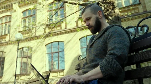 The programmer sits in the park  on a sunny day and writes a program Stock Footage 88782763
