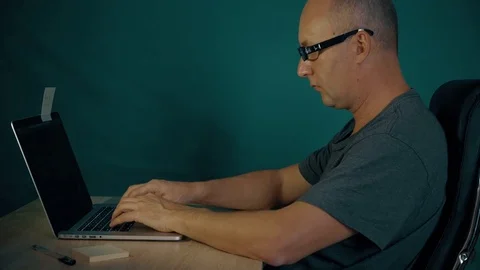 Programmer sits at table and coding on laptop computer. Man finger hands typing Stock Footage 82729534