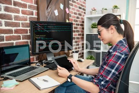 Programmer sitting and using tablet Stock Photos