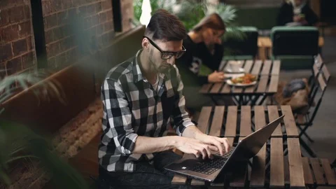 Programmer Sitting in Cafe Stock Footage 103744030