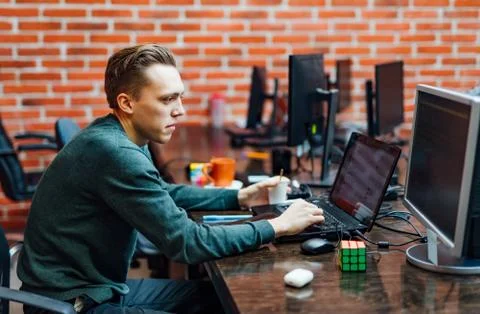 Programmer sitting at a desk with modern technologies 스톡 사진
