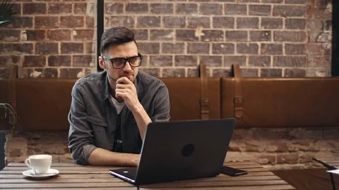 Programmer Sitting With Laptop in Cafe 動画素材 103740786