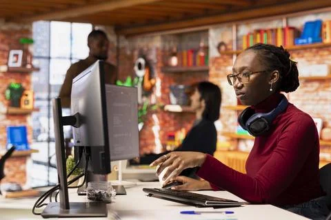 Programmer in startup office using large language model to get help with coding Stock Photos