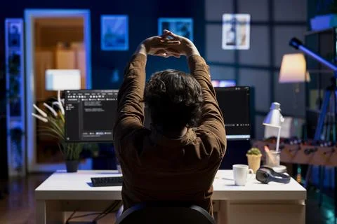 Programmer stretching body limbs after securing company servers all day Stock Photos