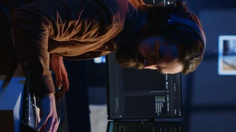 Programmer taking break from coding, putting headphones on and stretching Stock Footage 265109251