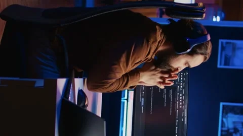 Programmer taking break from coding, putting headphones on and stretching Stock Footage 265109397