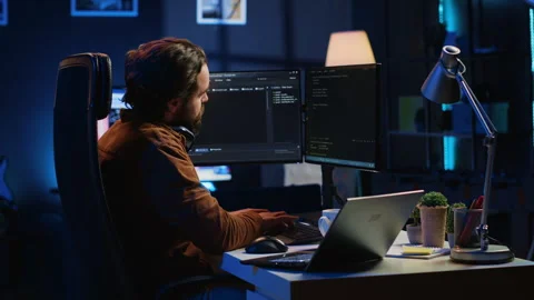 Programmer taking break from coding, putting headphones on and stretching Stock Footage 265621838