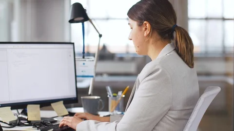 Programmer taking folder from colleague at office Stock Footage 105417631