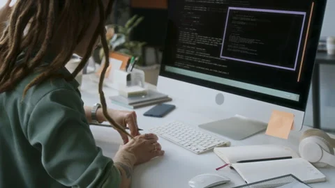 Programmer Taking Notes at Desk Stock-Footage 313492428