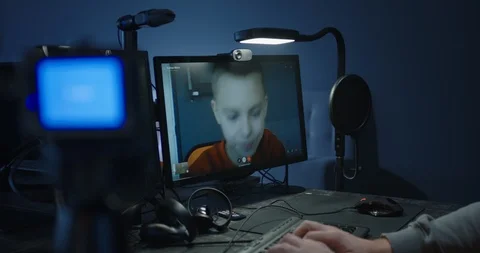 Programmer talking with a boy in a video call Stock Footage 125171408