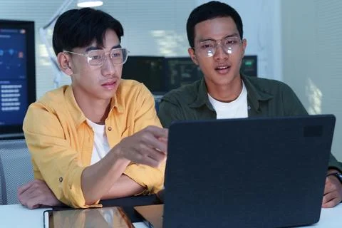 Programmer Team Collaborating on Software Development with Laptop Stock Photos