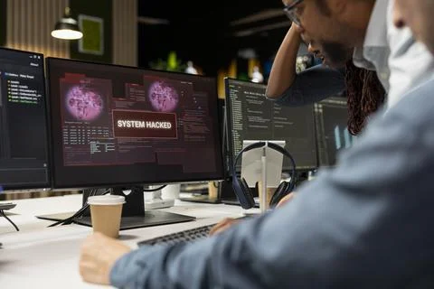 Programmer in tech company office trying to fix hacking attempt on network Stock Photos