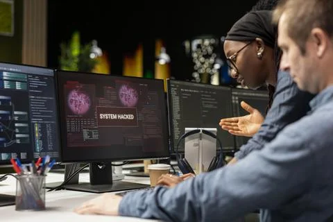 Programmer in tech company office trying to fix hacking attempt on network Stock-Fotos