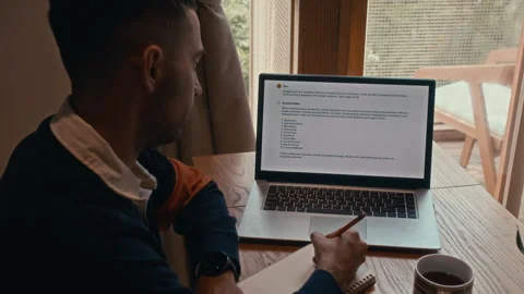 Programmer Testing Chatbot on Laptop at Home Office Stock Footage 285846827