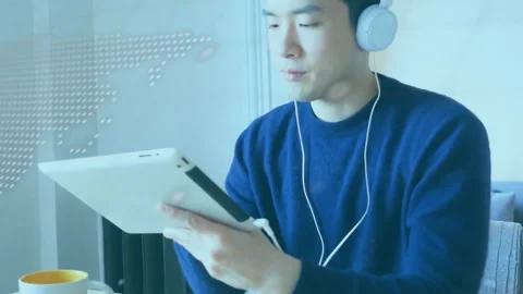 Programmer tilting tablet and tapping upon code and world map graphics appearing Stock Footage 313569908