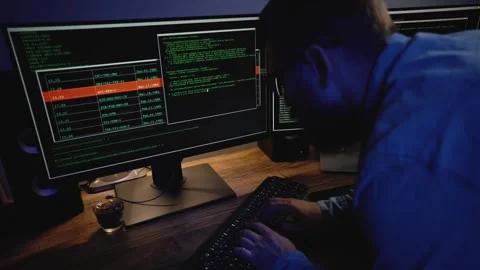 Programmer trying to fend off system hacking. Hacker writing scripts. Stock Footage 313402791