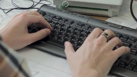 Programmer types code for new website on computer at table Stock Footage 194826483