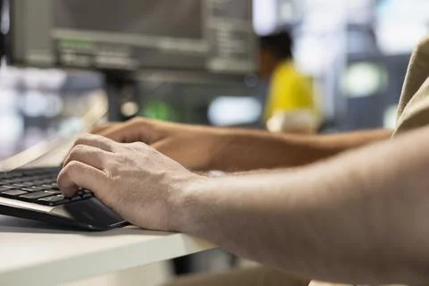 Programmer types on keyboard, testing company software Stock Photos