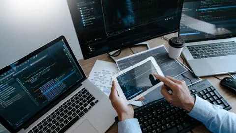 Programmer Typing Code on desktop computer, Developing programming and coding 写真素材