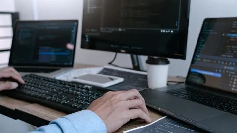 Programmer Typing Code on desktop computer, Developing programming and coding Foto stock