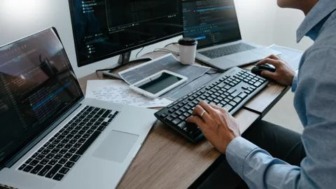 Programmer Typing Code on desktop computer, Developing programming and coding 写真素材