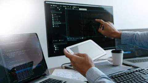 Programmer Typing Code on desktop computer, Developing programming and coding 库存照片