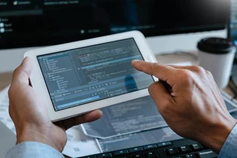 Programmer Typing Code on desktop computer, Developing programming and coding Stock Photos