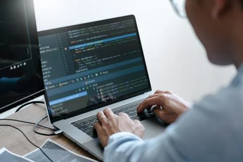 Programmer Typing Code on desktop computer, Developing programming and coding 写真素材