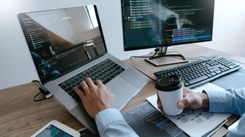 Programmer Typing Code on desktop computer, Developing programming and coding Foto stock