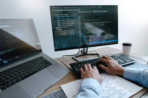 Programmer Typing Code on desktop computer, Developing programming and coding Stock Photos