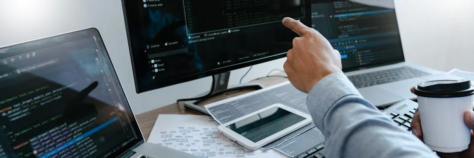 Programmer Typing Code on desktop computer, Developing programming and coding Foto stock
