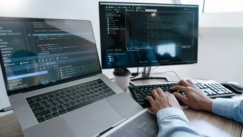 Programmer Typing Code on desktop computer, Developing programming and coding Foto stock