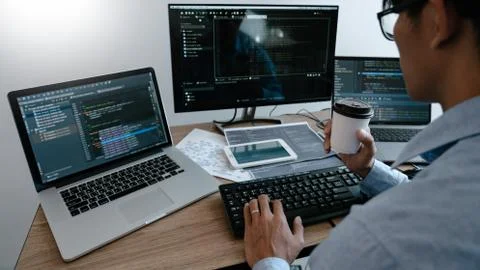 Programmer Typing Code on desktop computer, Developing programming and coding Foto stock