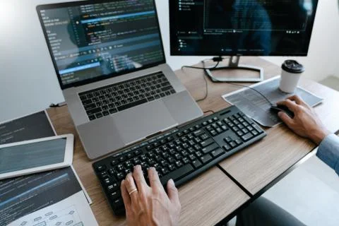 Programmer Typing Code on desktop computer, Developing programming and coding Stock-Fotos