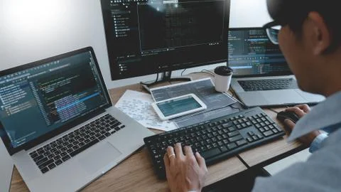 Programmer Typing Code on desktop computer, Developing programming and coding 库存照片