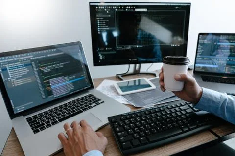Programmer Typing Code on desktop computer, Developing programming and coding Stock Photos